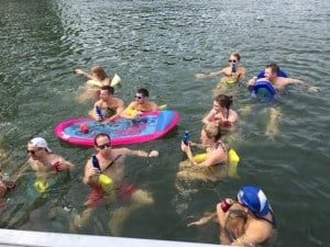 Students from the 2016, 2017 and 2018 Evening MBA program cooling off in the waters of Lake Allatoona during Boat Day 2015. 