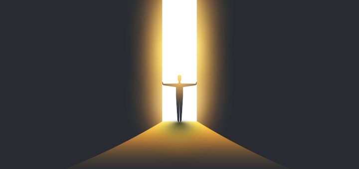 Businessman Standing in Dark, Symbol of Light at the End of the Tunnel