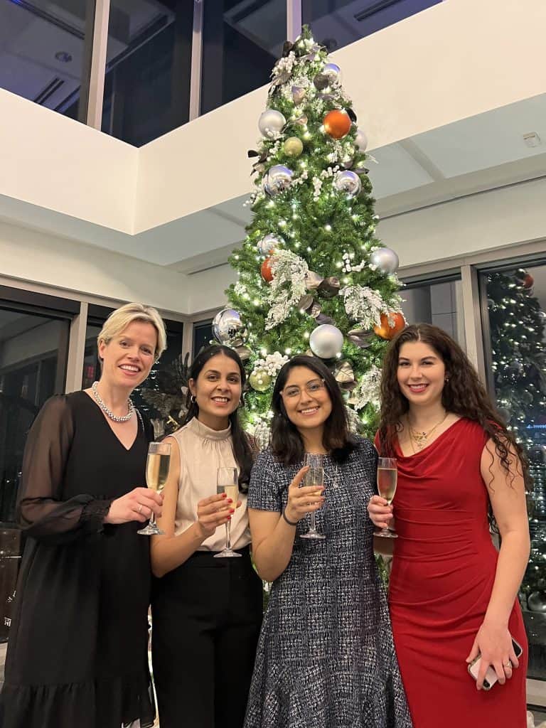 MAF Students with Dr. Kirsten Travers-UyHam, Academic Director, at the Winter Holiday party at Invesco