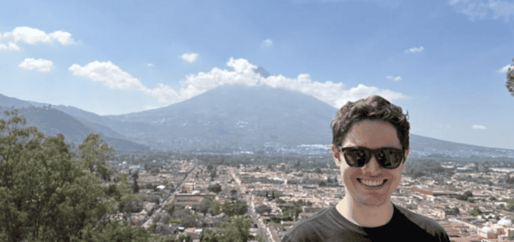 Michael Coyne 26MBA above Antigua on Cerro de la Cruz with the town and volcano in the background