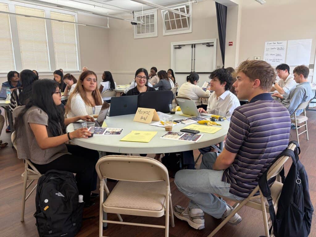 Student participants collaborating on presentations to advocate for their nonprofit partners.