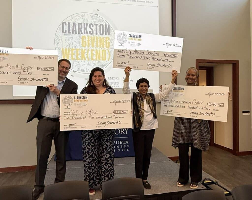Each of the four participating nonprofits receiving their grant award.
