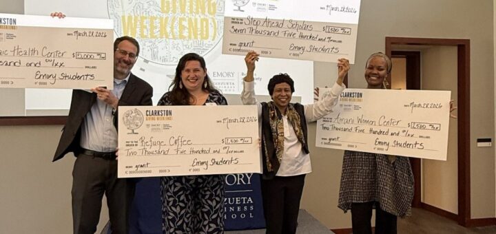 Each of the four participating nonprofits receiving their grant award.